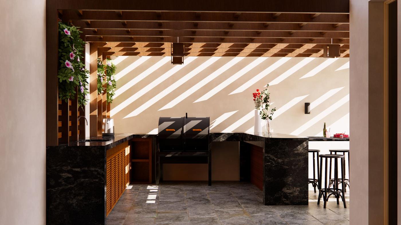 Outdoor kitchen under a timber pergola casting striped shadows